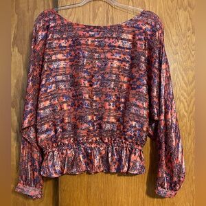 Orange and blue ornate blouse.
